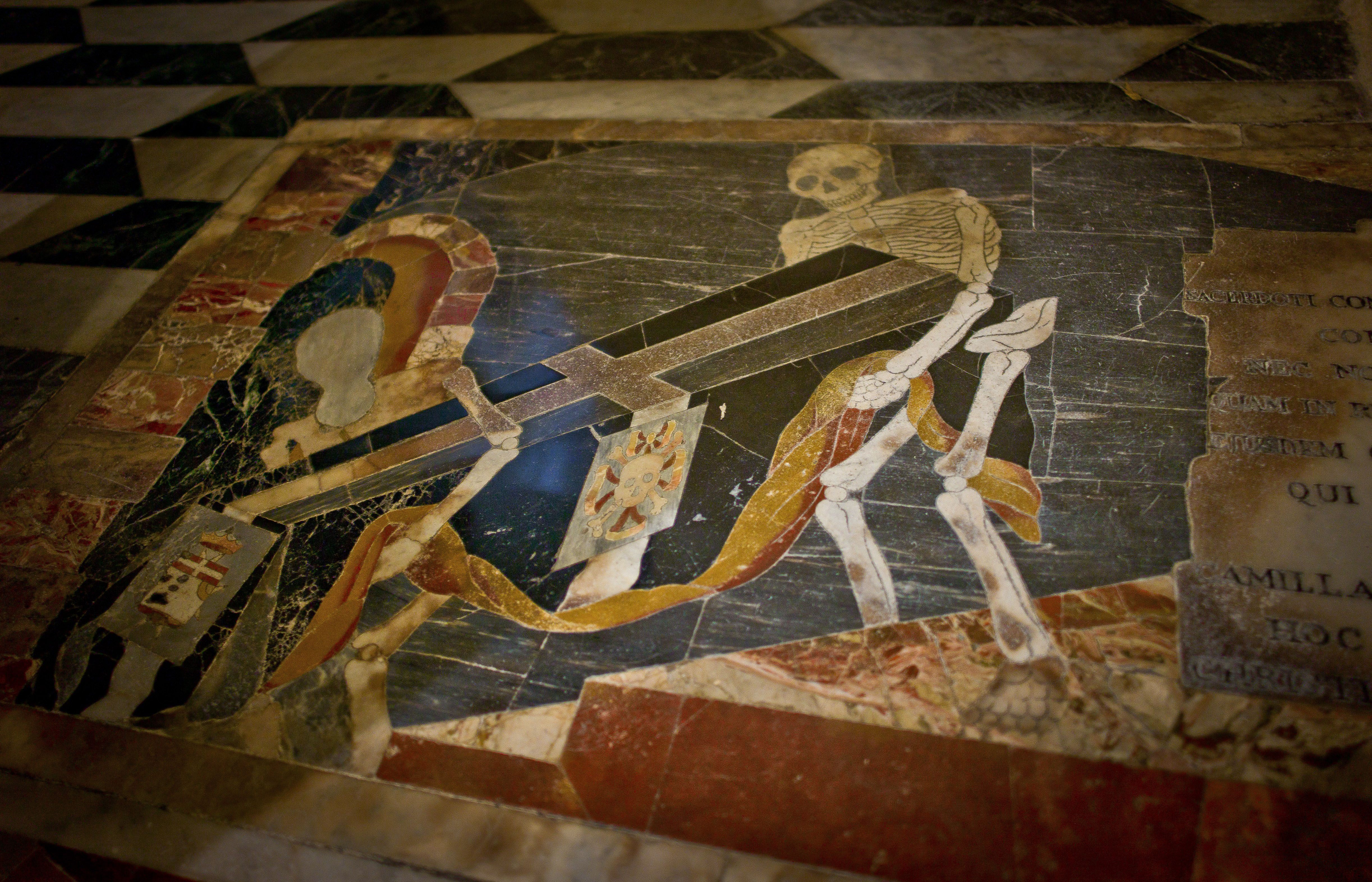 A commemorative plaque on the marble floors of the Cathedral of St. John's Co-Cathedral in Valletta, Malta.