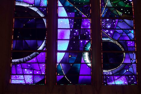 The artist Rodney Winfield went back and forth on 11 versions of the window with officials at NASA and the National Cathedral. Finally he came up with this geometric design that pleased all parties.