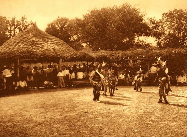 This photograph from around 1930 shows Native spectators gathered beneath the circular arbor.