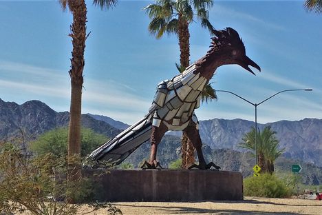 The giant metal roadrunner watches traffic from the middle of the rotary.