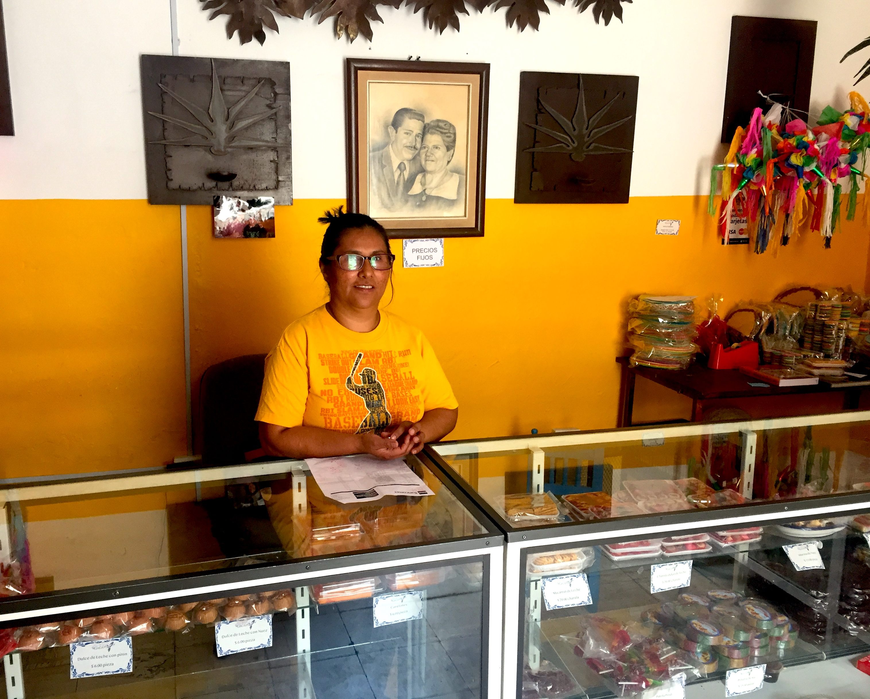 Cecilia Reyes Mendiola, who owns El Colibrí with her husband José Emilio, stands behind the counter with her wares. 