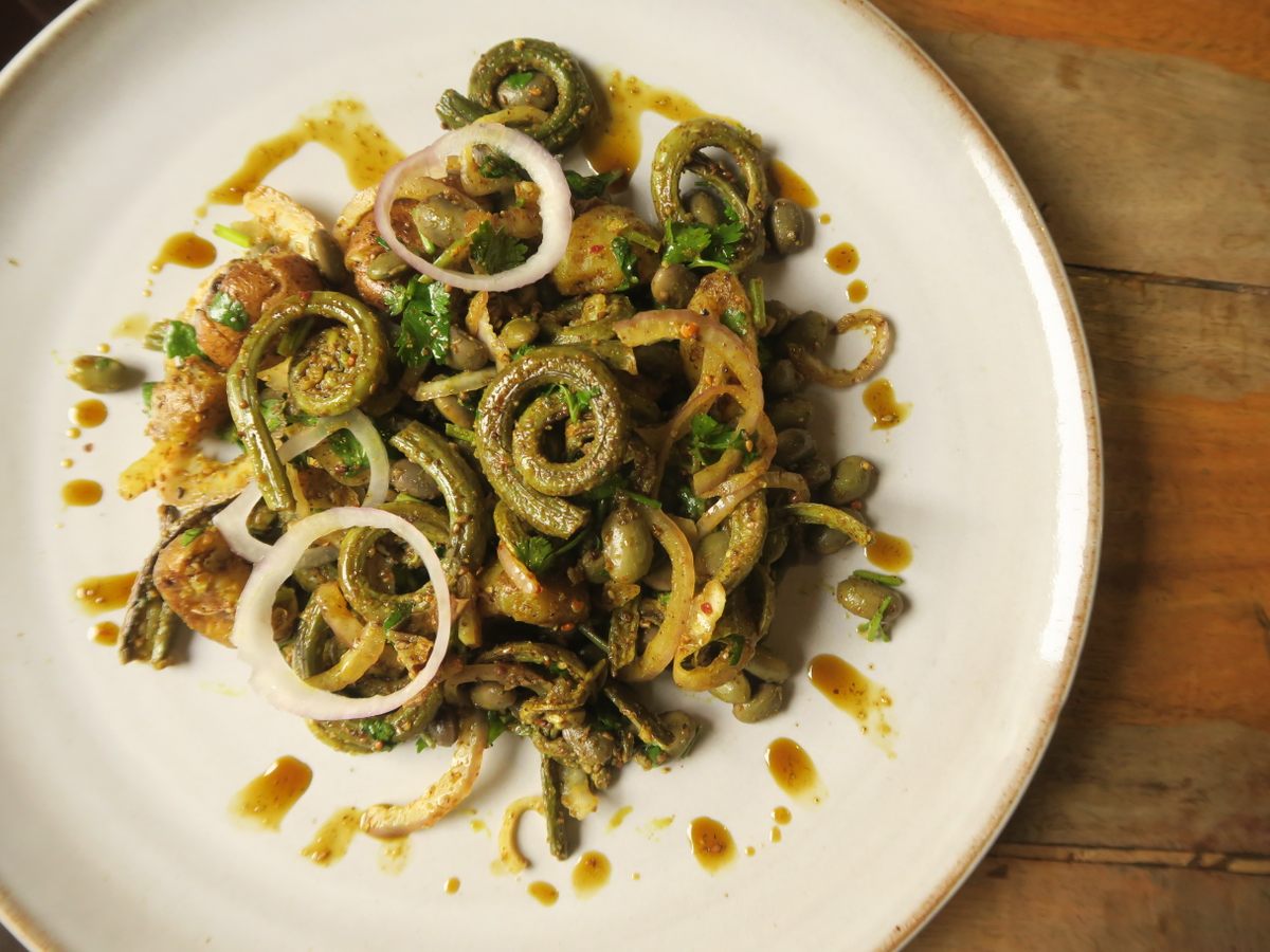 Niuro salad is made with fiddlehead fern and flavored with roasted sesame seeds powder, timmur (nepali pepper), and mustard oil.