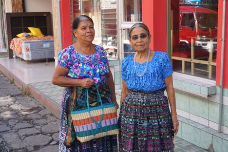 Local women holding rubber bags.