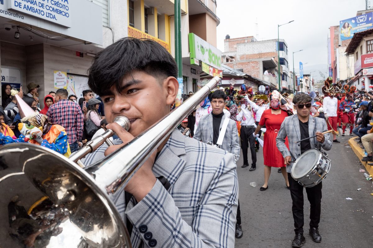 The band marches along the procession route in Píllaro on the first day of the Diablada of 2023.