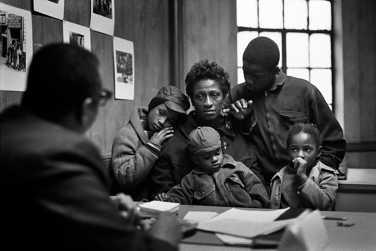 Asked to document Black poverty in America, Parks returned to Harlem in 1967 to photograph the Fontenelle family. The heartbreaking images of their struggles—including this one of Bessie Fontenelle at the Poverty Board with Kenneth, Little Richard, Norman Jr., and Ellen—inspired Parks to write in <em>LIFE</em>, 