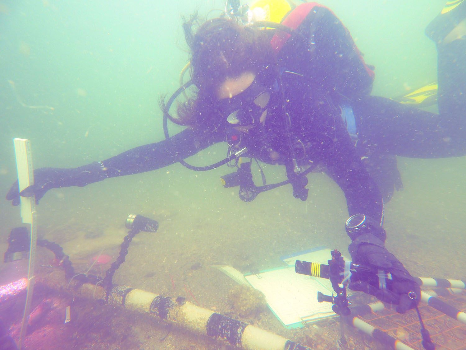Measuring the depth of the gravesite.