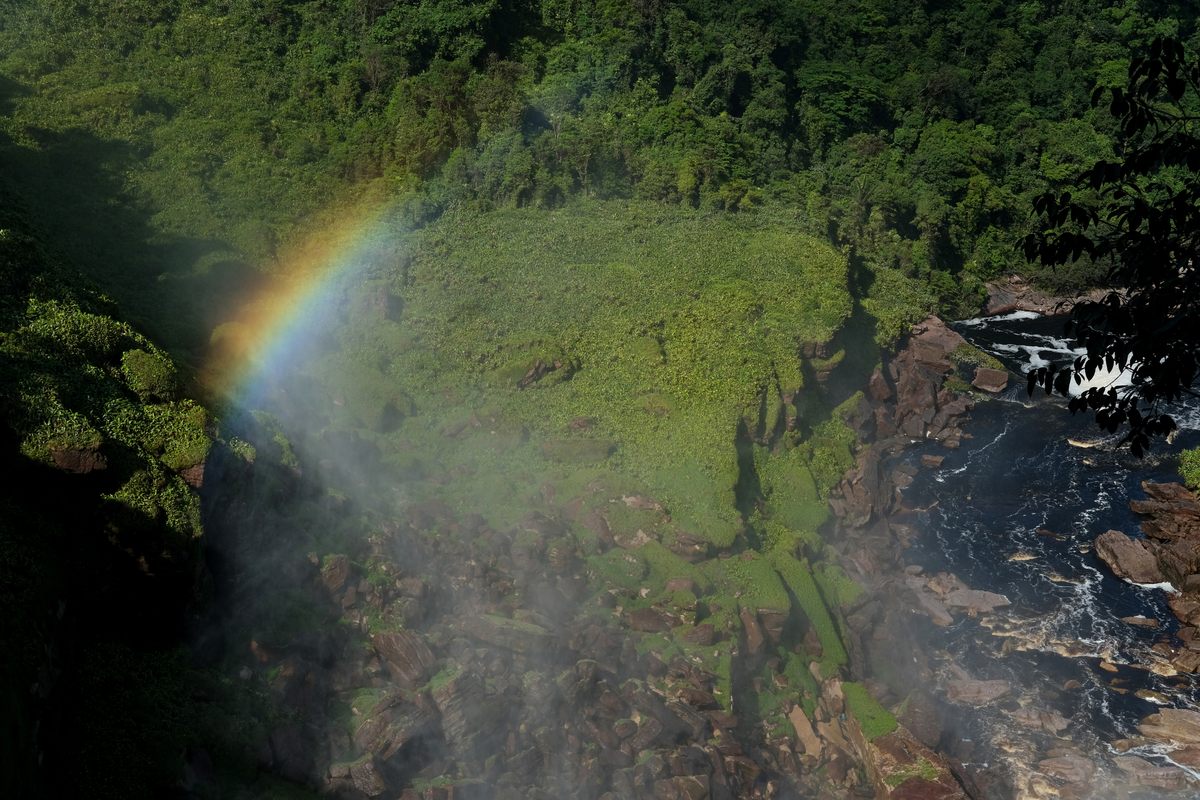 A rainbow appears in mist rising from Kamarang Meru, one of Guyana's most remote waterfalls.