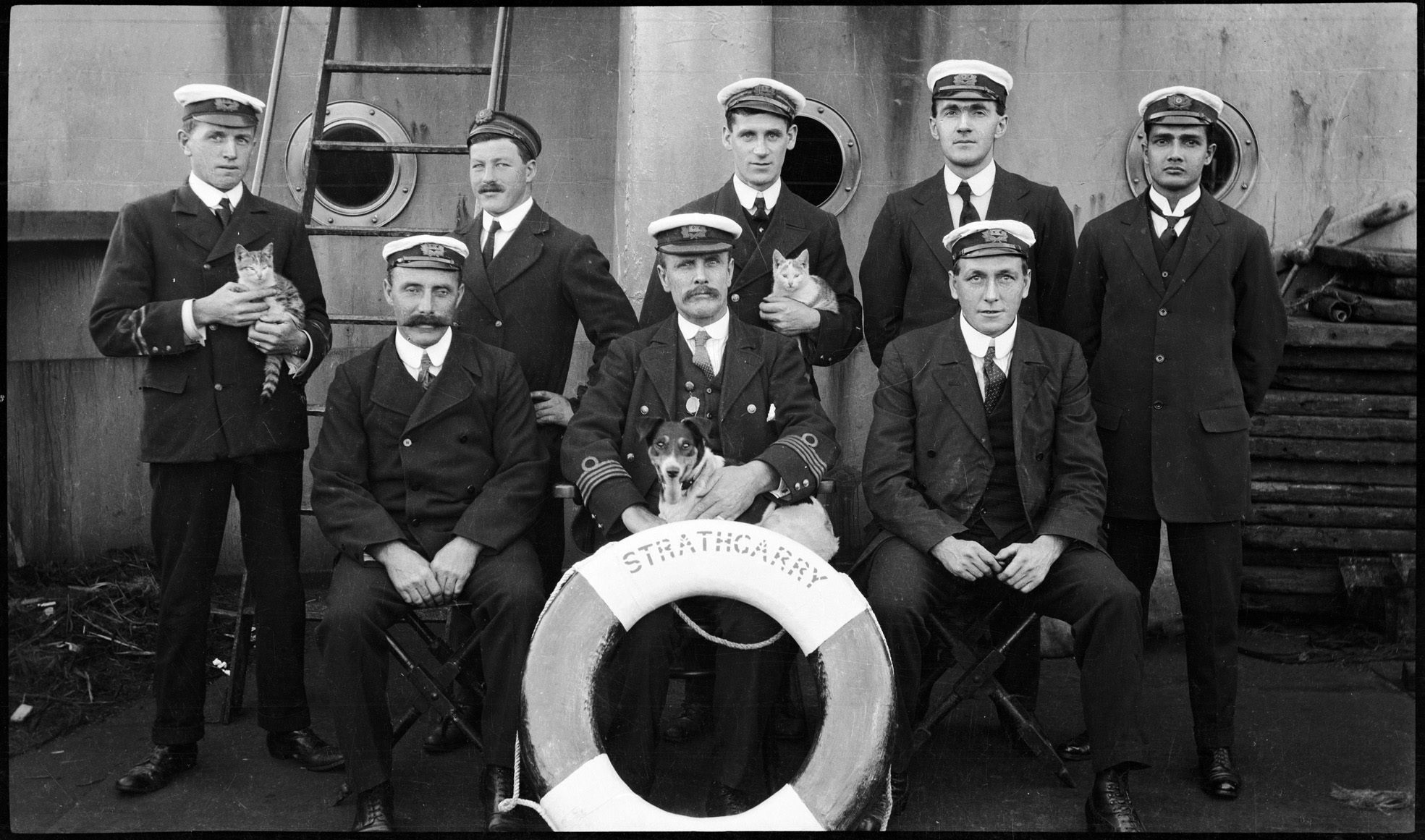 The crew of Scottish steamer SS <em>Strathgarry</em>, with the captain's terrier and two cats.