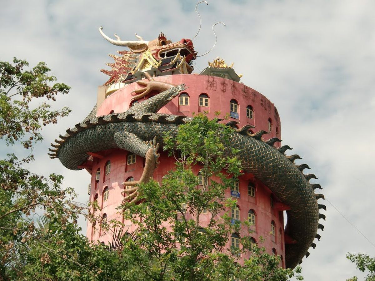 The entire body of the dragon spiraling up Thailand's Wat Samphran Temple hides a tunnel.
