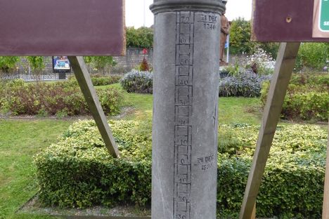 The column indicating the level of 5 floods behind the monument.