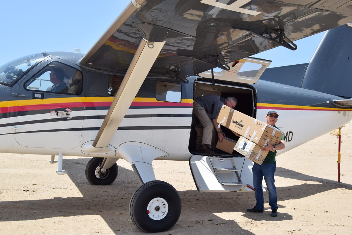 Olivier d'Agay, great-nephew of author and pilot Antoine de Saint-Exupéry, helps unload deliveries for the first rally plane to land in Tarfaya in 2023.