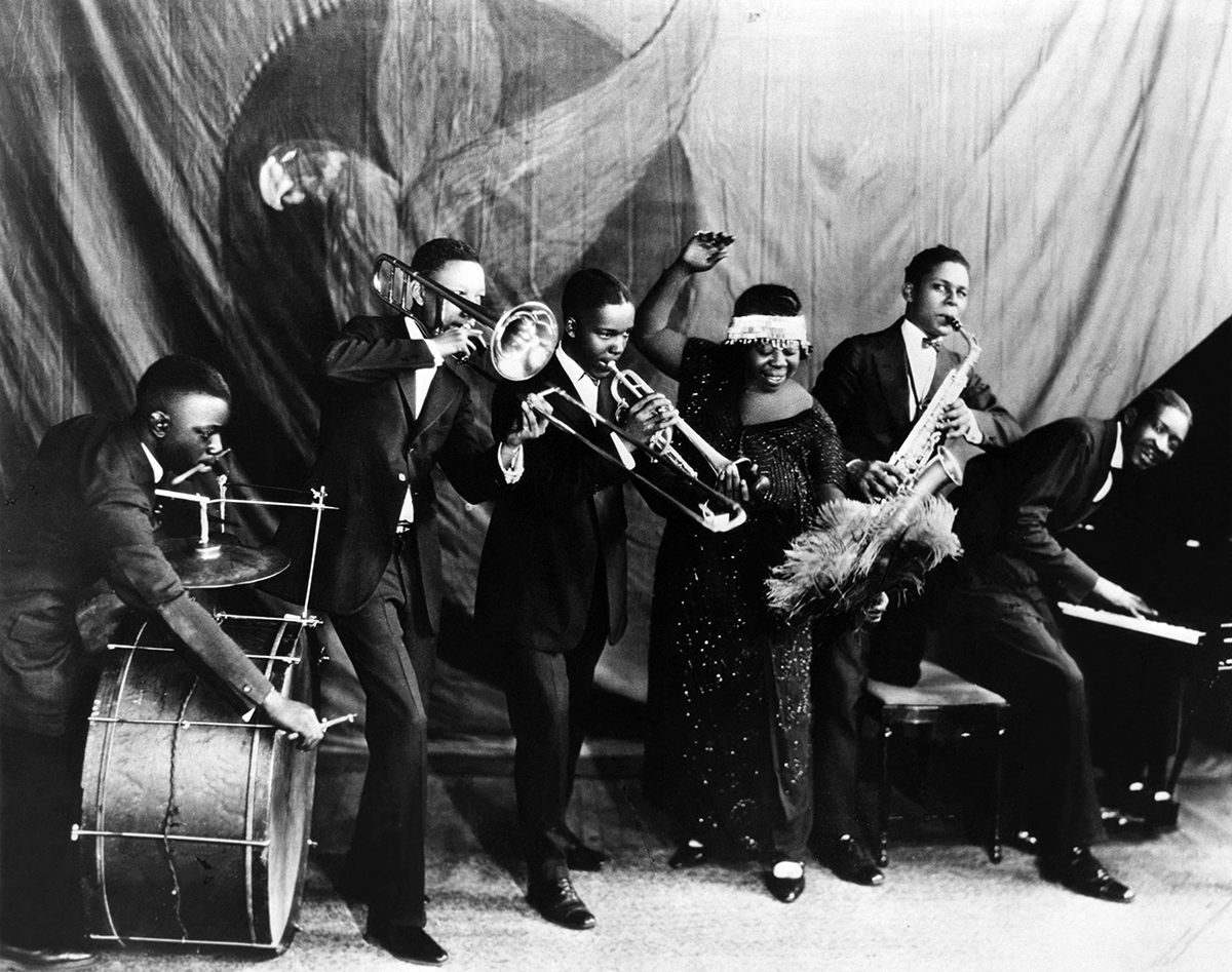 Ma Rainey poses for a studio group shot with her Georgia Jazz Band in 1924 or 1925. 