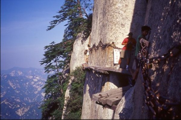 Visitors cling to chains above a mile-high precipice 