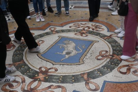 The Dancing Bull is found in front of Dior and Swarovski stores, the left turn from the main entrance looking to Duomo.