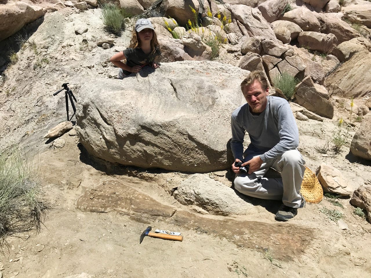 Ruby Foster and Brian Engh with the humerus in June, before it was excavated.