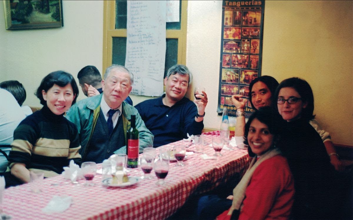 Kwan, center, drinking wine to the right of restaurateur Foo-Ching Chiang in Argentina. 