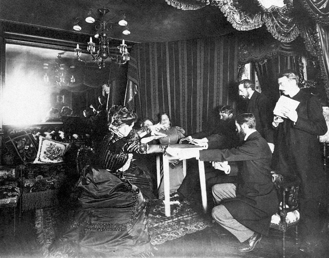 Medium Eusapia Palladino performs a séance at the French home of astronomer Camille Flammarion on November 24, 1898.