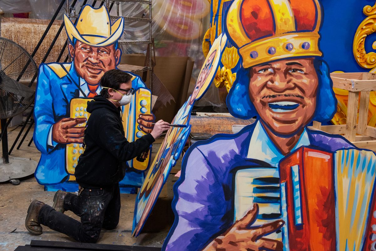 Artist Ryan Blackwood paints cutouts for the "Acadiana Hay Ride" house float.