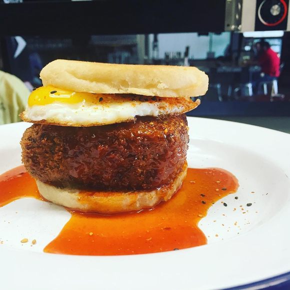 A breaded scrapple and egg sandwich.