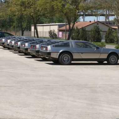 DeLoreans line up outside the repair facility.