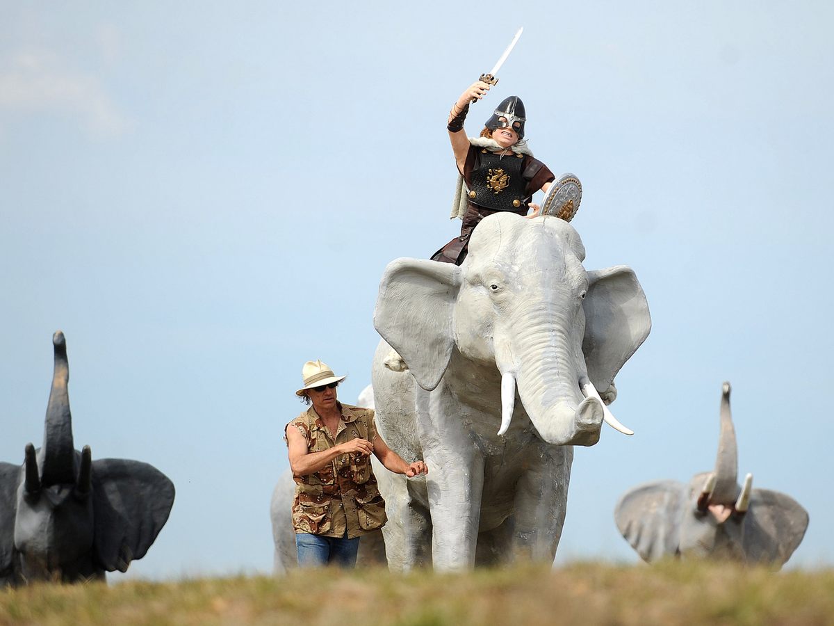 Mark Cline walks around his creation of Hannibal aboard one elephant leading four other elephants on March 31, 2009.