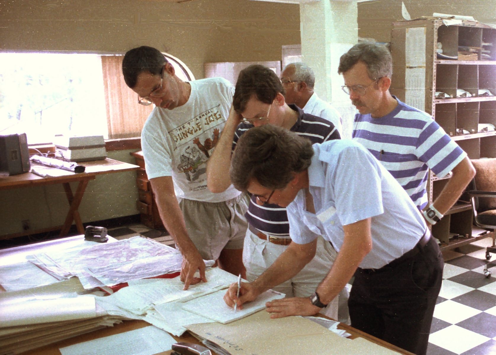 Frank Marks, James Franklin, Bob Burpee, and Hugh Willoughby plan NOAA research flights into Hurricane Gabrielle. Barbados. 1989 