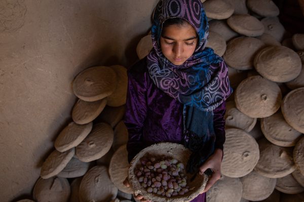 Sabsina, 11, holds a bowl of grapes that were placed inside months earlier.