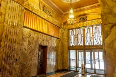 The golden entry of the Philcade building, with zig zag style Art  Deco elements.