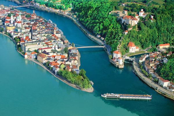 An AmaWaterways river ship approaches Passau, Germany, where the Danube, Inn, and Ilz rivers meet.