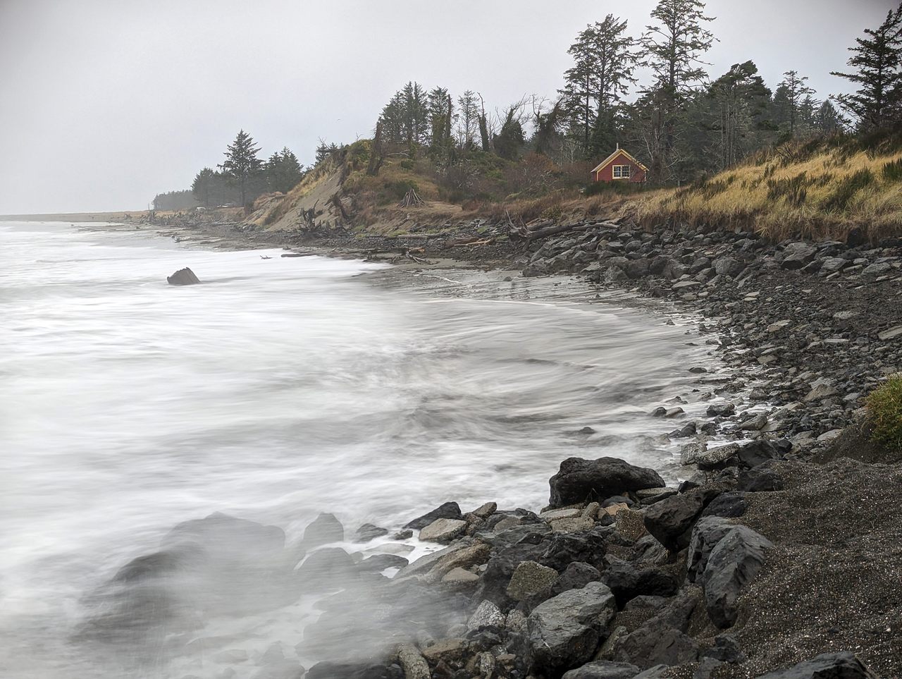 Washington’s seasonal king tides, shown here at Washaway Beach in November 2022, are becoming more destructive as sea levels rise. Local leaders have spread an experimental cobble berm along the shore to help stem erosion.