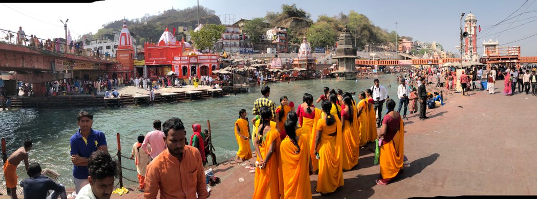 Hindu pilgrims in orange gather at the Ganges River in India.