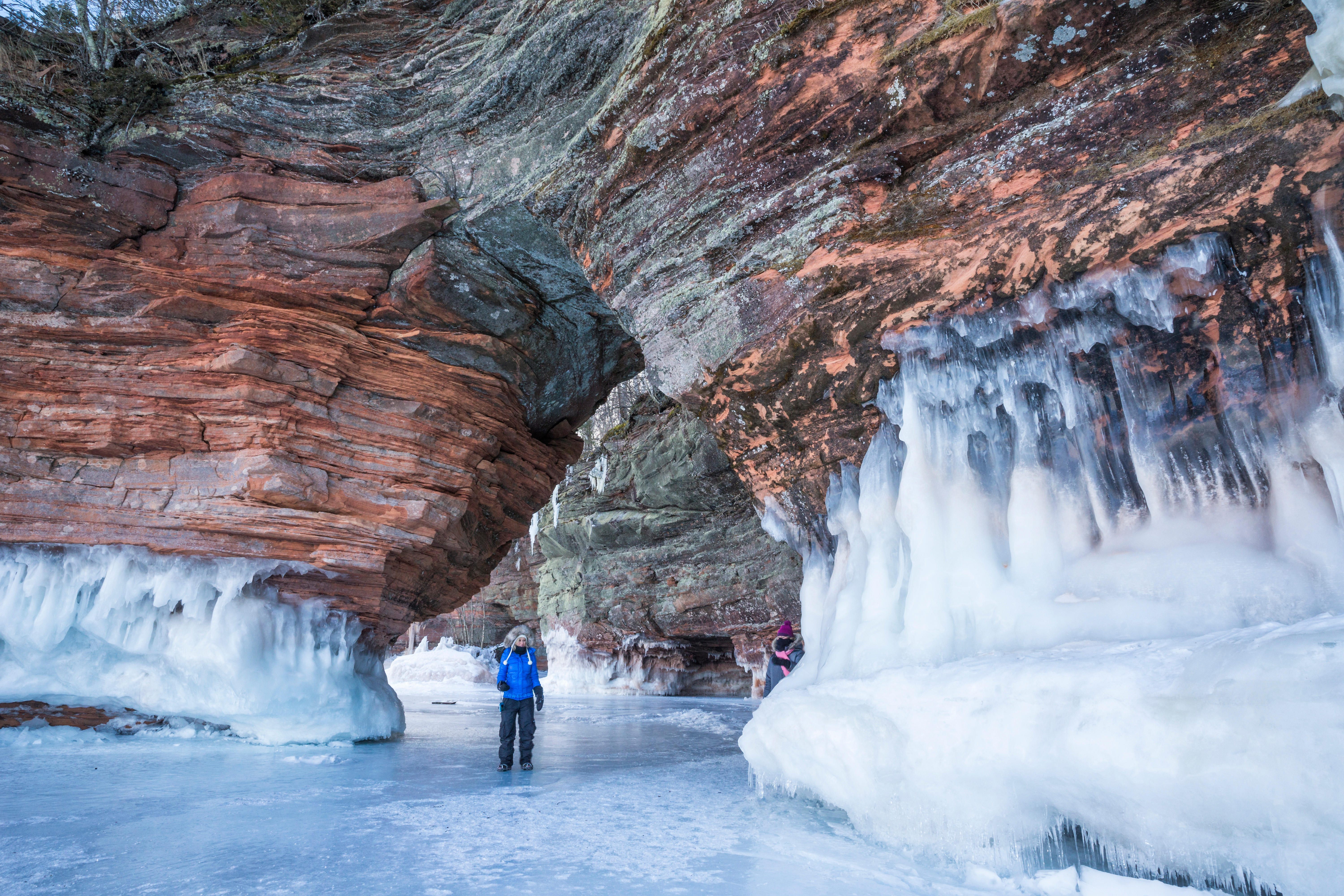 Walking through a sandstone arch at the Apostle Island ice caves.