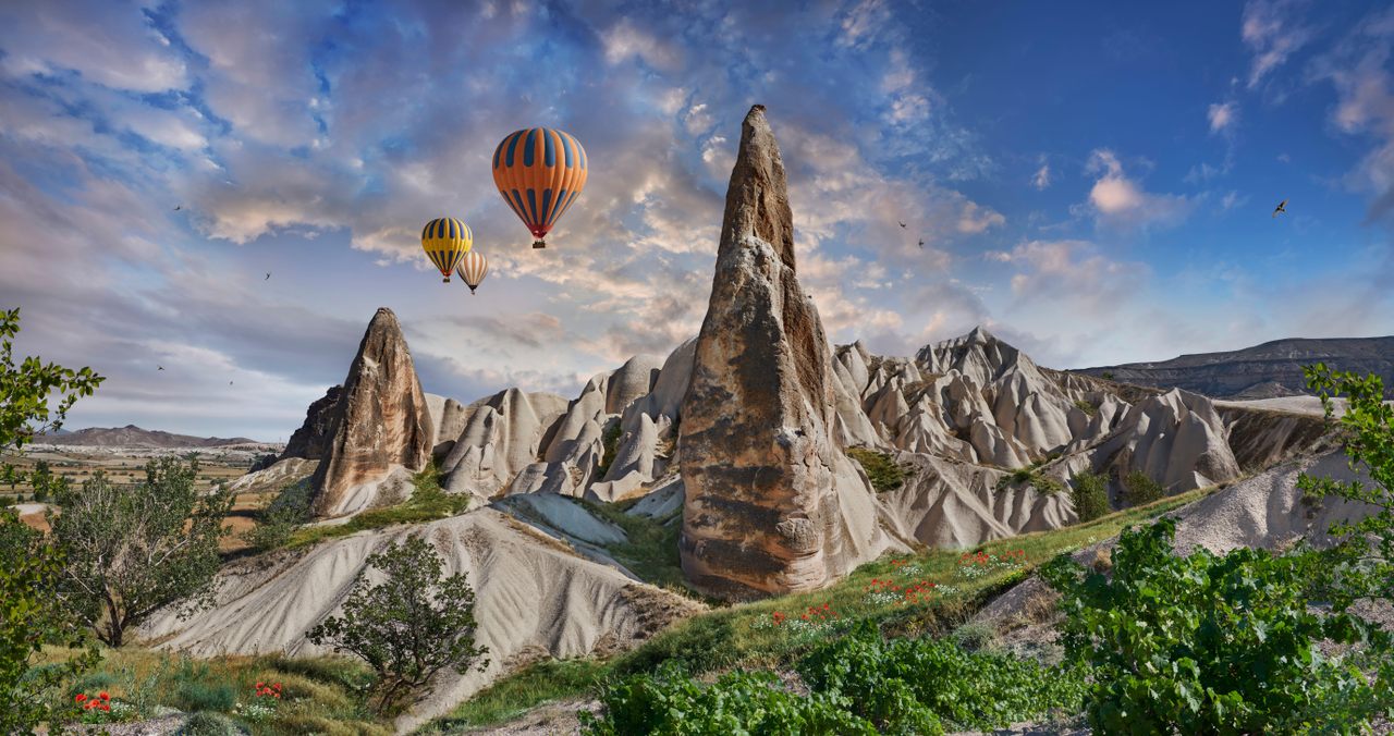 Hot air balloons over the Fairy Chimney rock formations in Cappadocia.