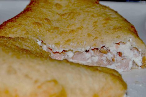 A pizza fritta stuffed with ricotta and cicoli (fatty pork).