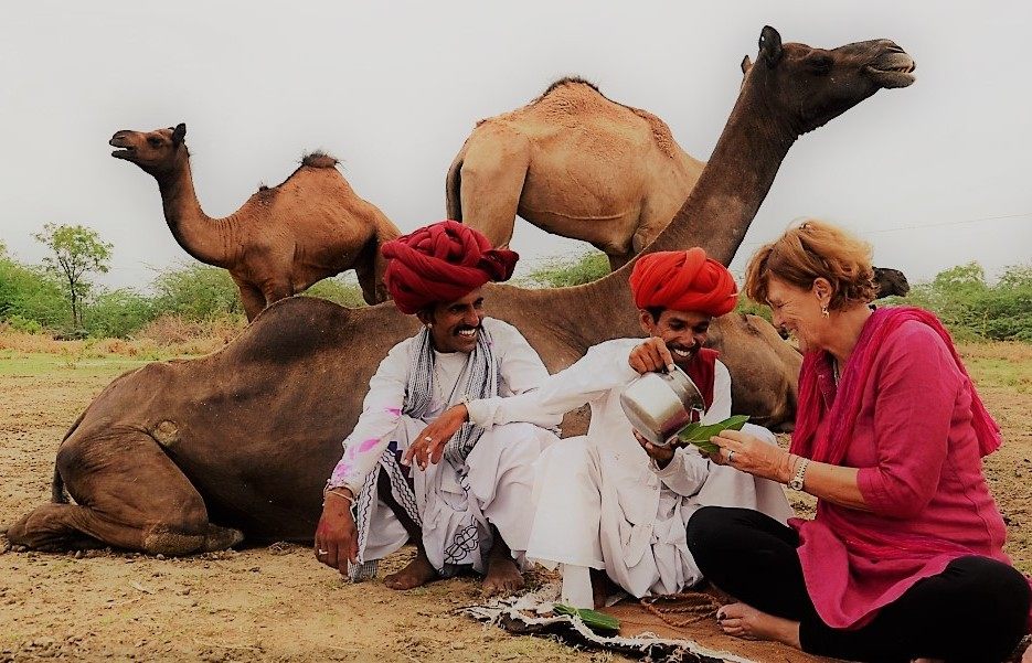 Dr. Ilse Köhler-Rollefson shares camel milk with two herders.
