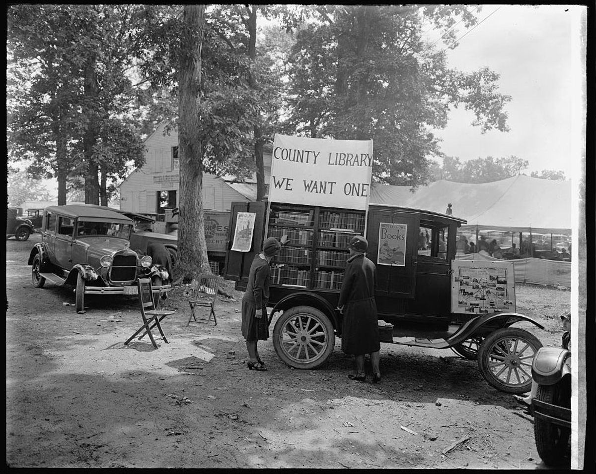 Mobile library, with the sign "County Library: We Want One," Rockville Fair, Maryland, 1928.