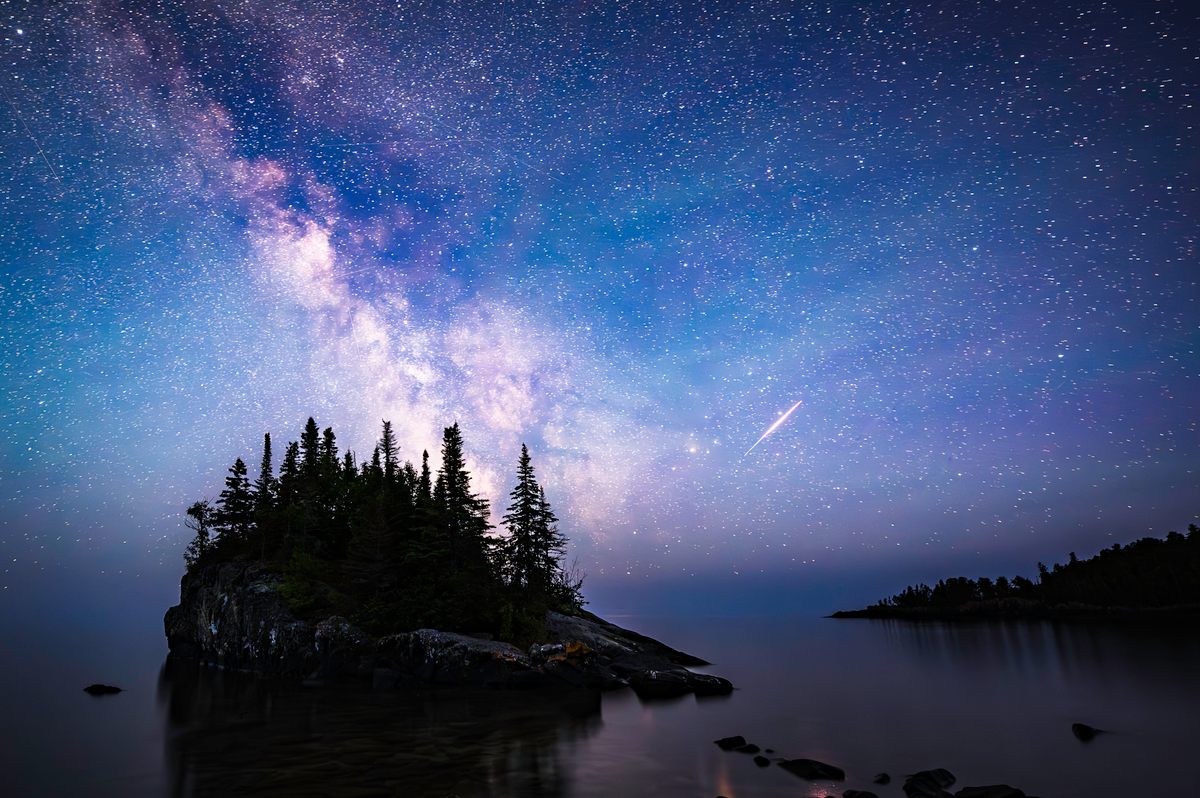 Katie Steig's photograph of the Milky Way with an Iridium satellite flare over The Rock at Lake Superior in Hovland, Minnesota.