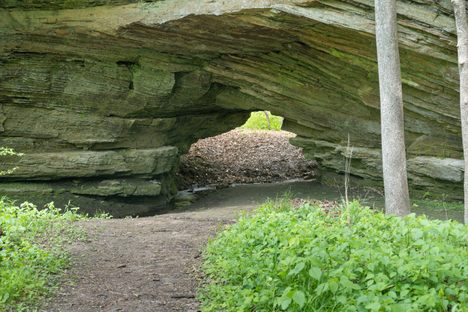 A wall of sandstone with a small opening 