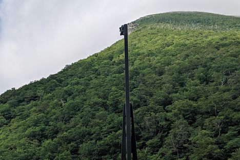 The metal pillars aligned to form the Old Man's face