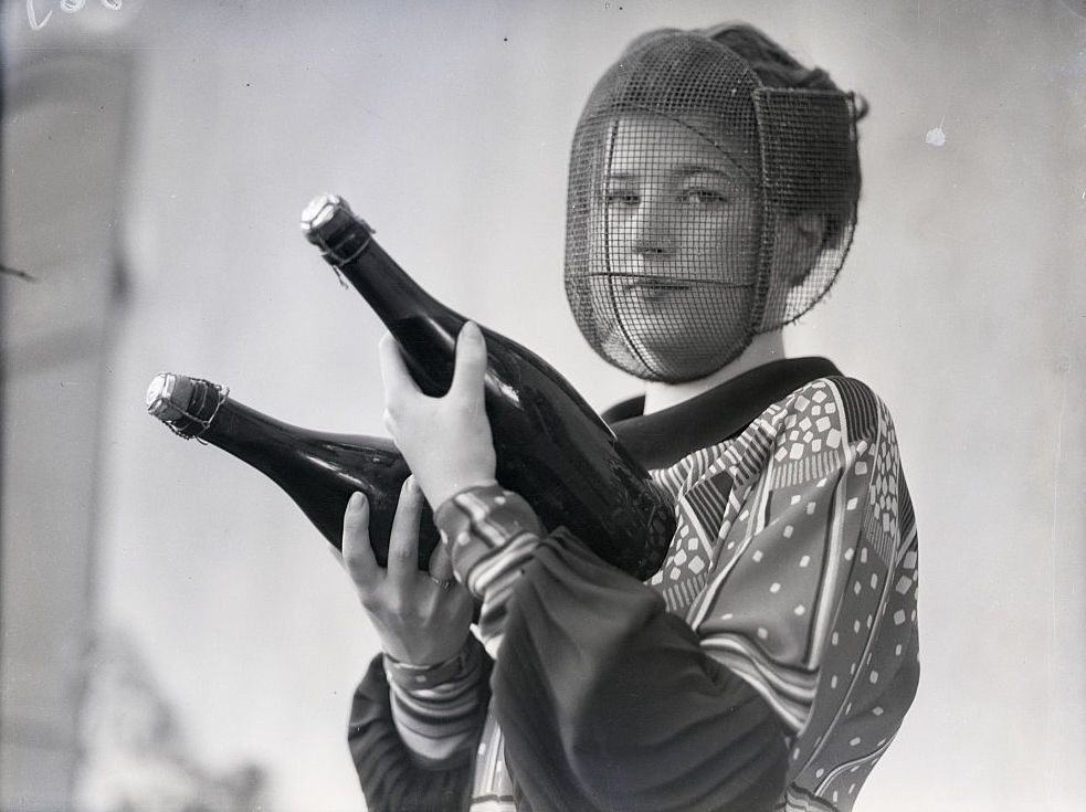 This Champagne inspector wears a mask to protect her face from shattering bottles. 