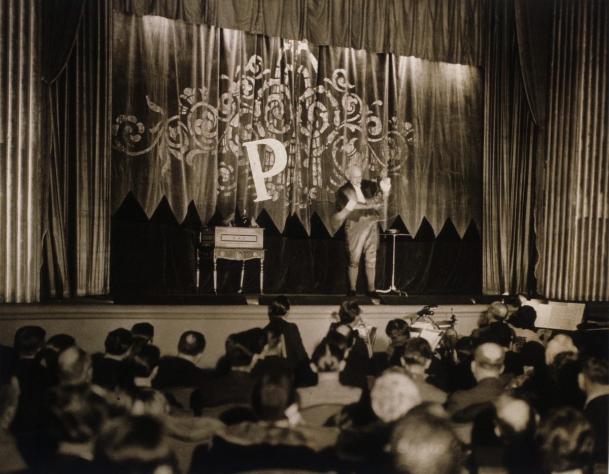 Frederick Eugene Powell, 2nd Dean of American Magicians, performing on the stage of the Heckscher Theater, 1929.