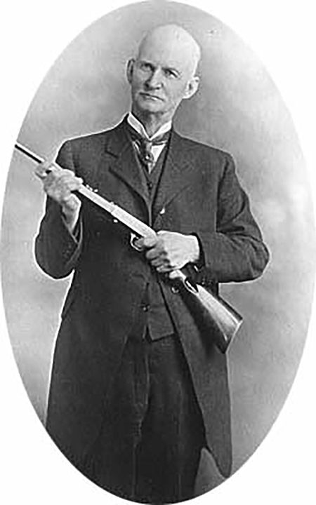 John Browning holding a Browning semi-auto .22 rimfire rifle
