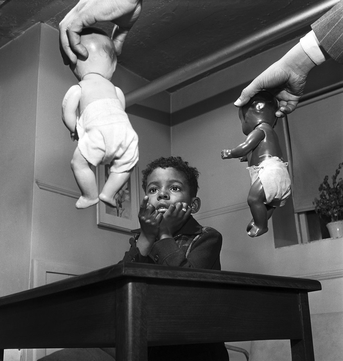 This photograph, taken by Parks in Harlem in 1947 for <em>Ebony</em>, captures a decisive moment. The unidentified boy was asked to choose one of the two dolls to play with; he chose the white one. This “doll test,” designed by psychologists Kenneth and Mamie Clark, ultimately found that prejudice and segregation created feelings of inferiority among Black children. 