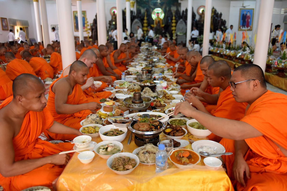 Monks feasting on offerings during Pchum Ben.