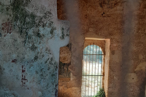 Through the rusty bars to the abbey's interior