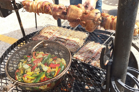 Bacon-wrapped squirrel, grilling at the 2014 World Champion Squirrel Cookoff.