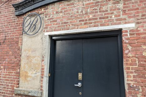 Ornate metal "B" sign.