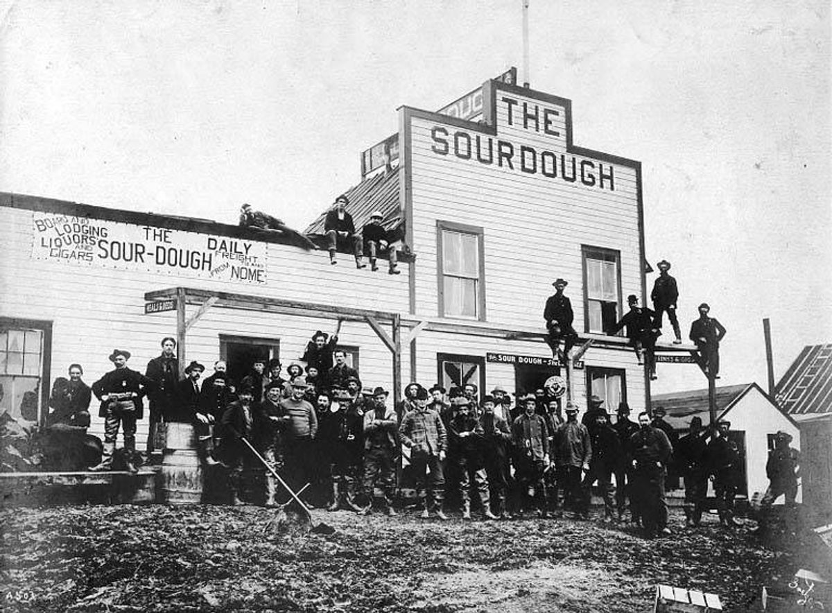 A group of men in front of the Sourdough Hotel in Dexter, Alaska, in the early 1900s.