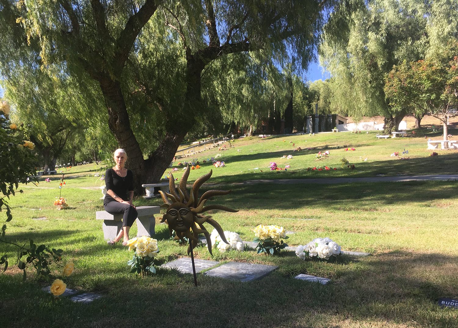 Shera Danese-Falk sits next to her pets’ plot.