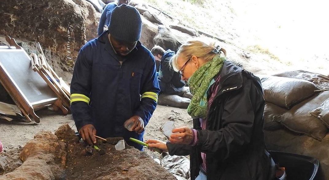Archaeologists Joshua Kumbani (left) and Sarah Wurz (right) work at a site near the Klasies River in South Africa.